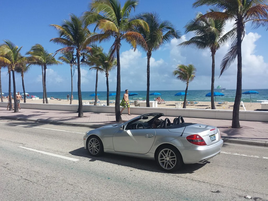 Sandy Miami Beach with dune grass under a clear sky.
